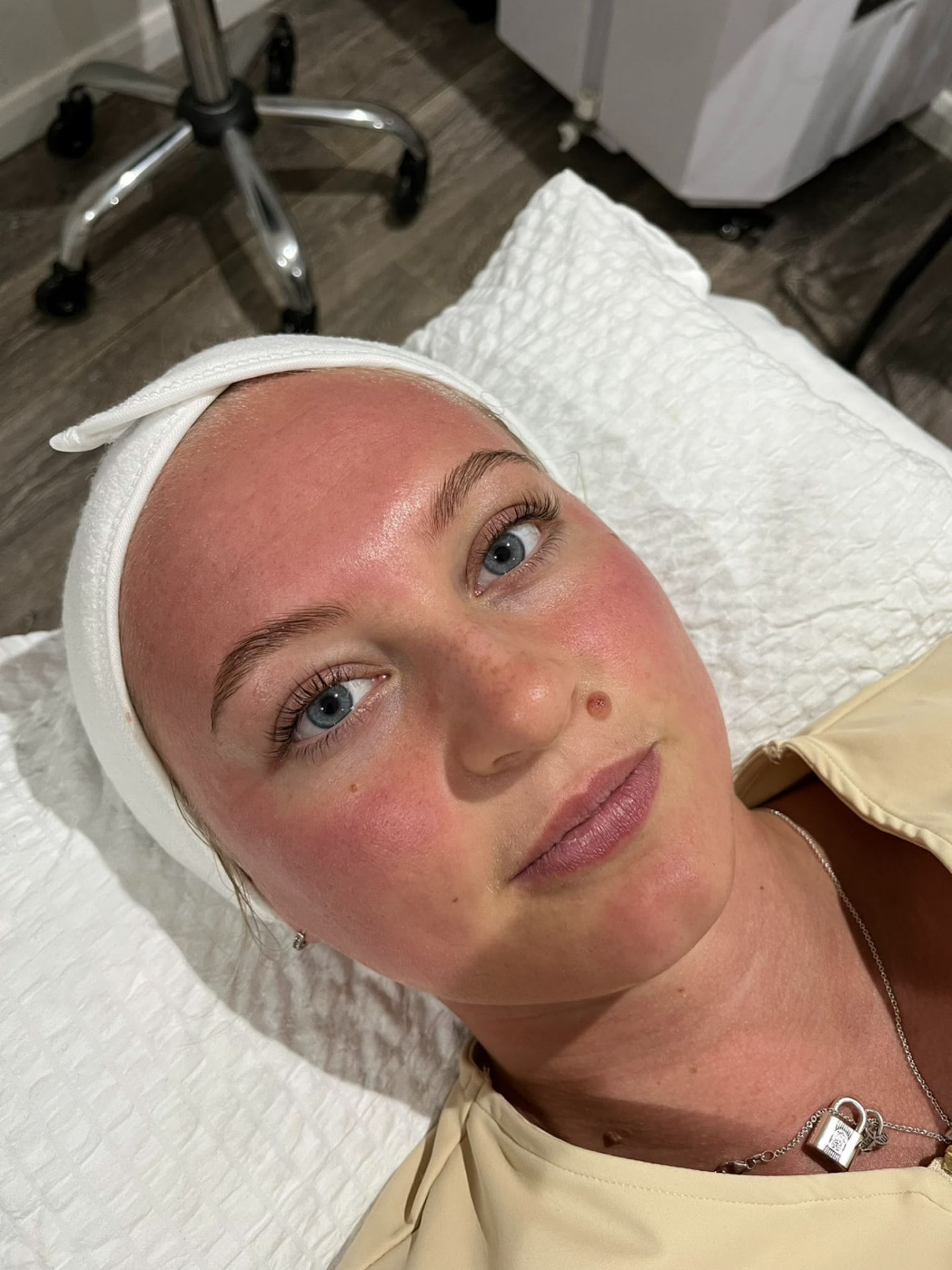 Client showing a fresh post-facial complexion after a professional skin treatment