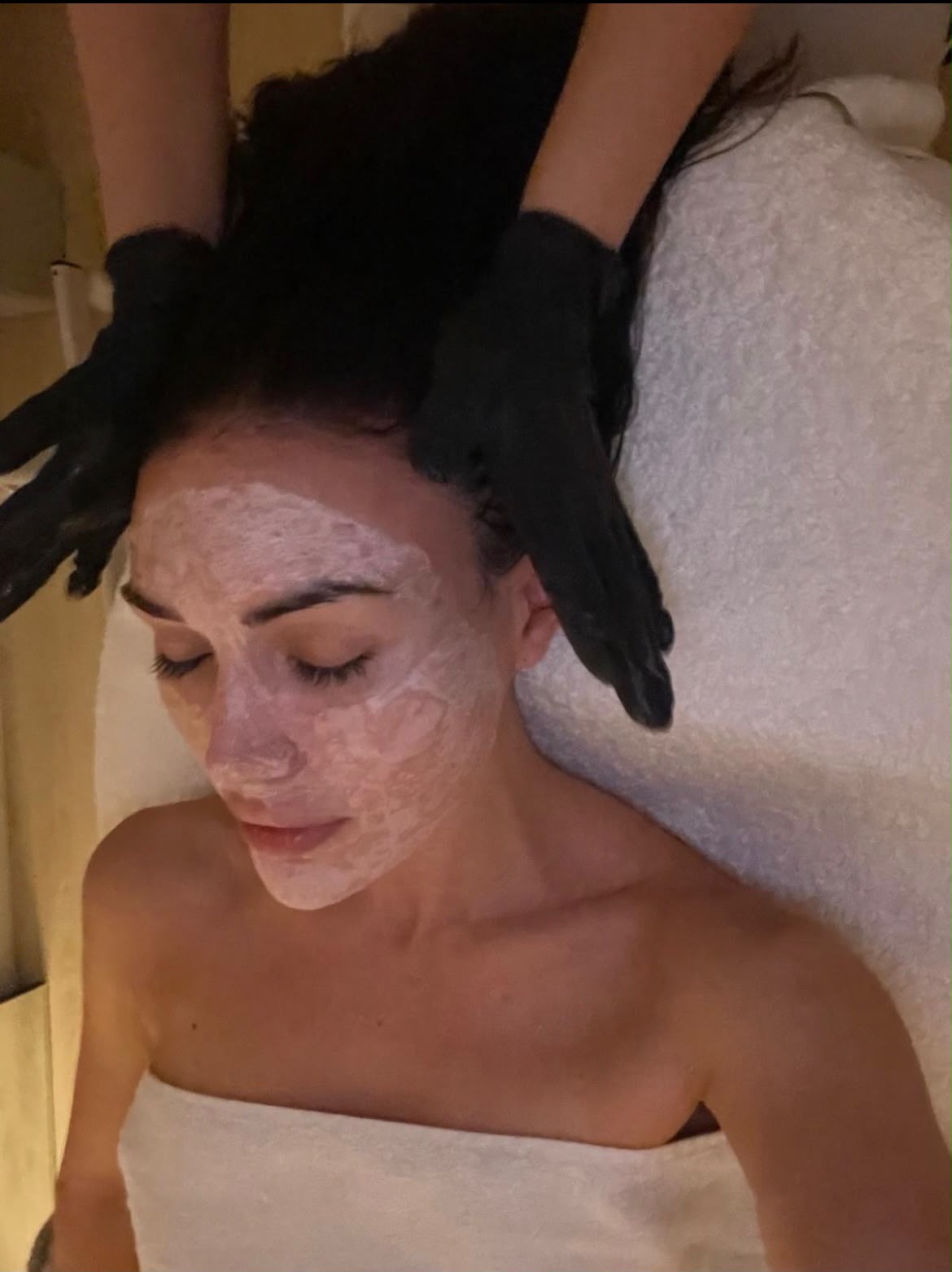 Facial treatment mask applied while a client receives a professional skincare treatment